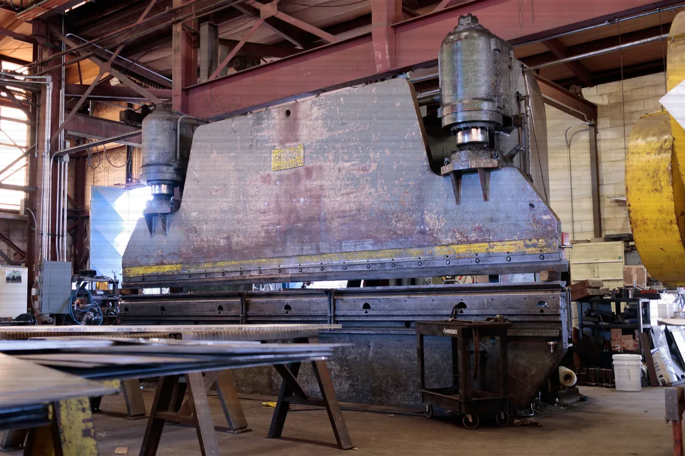 A press brake standing in a fabrication shop