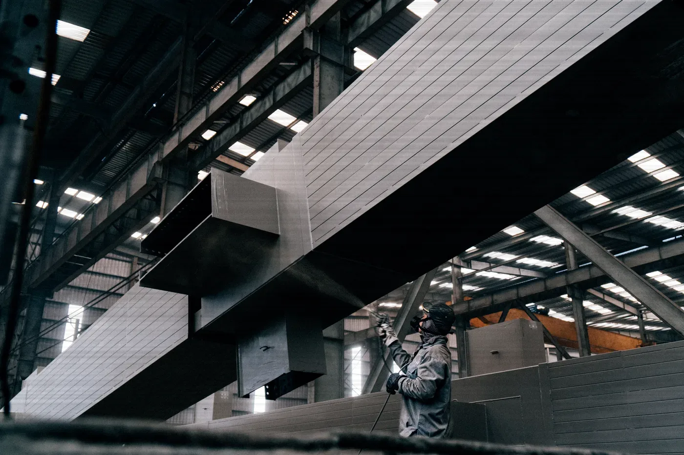 Steel beams under the roof of a fabrication shop