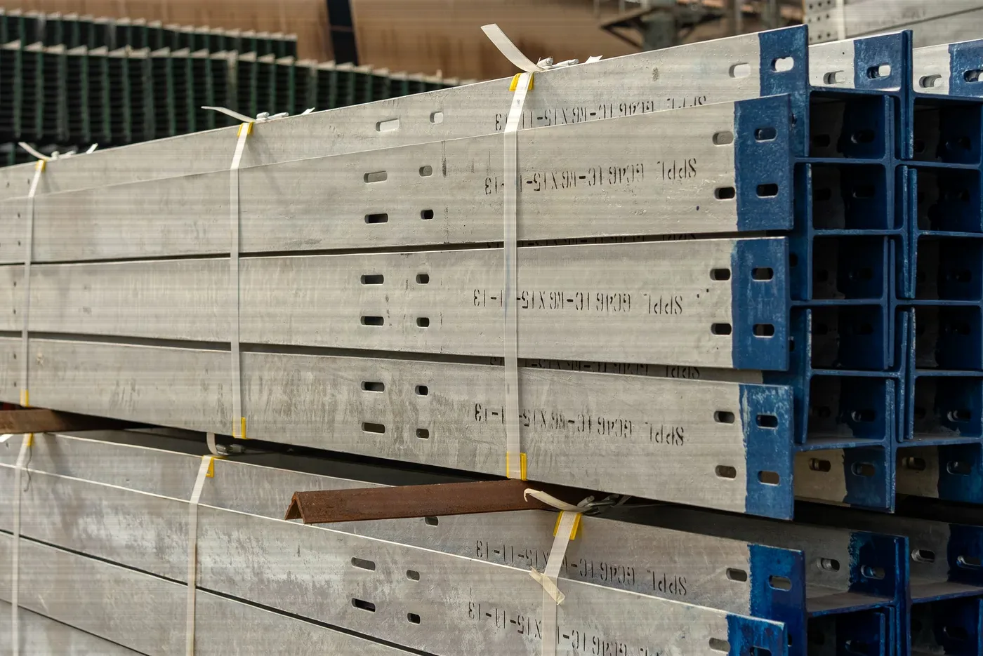 Bundled galvanised steel sections stacked in a warehouse